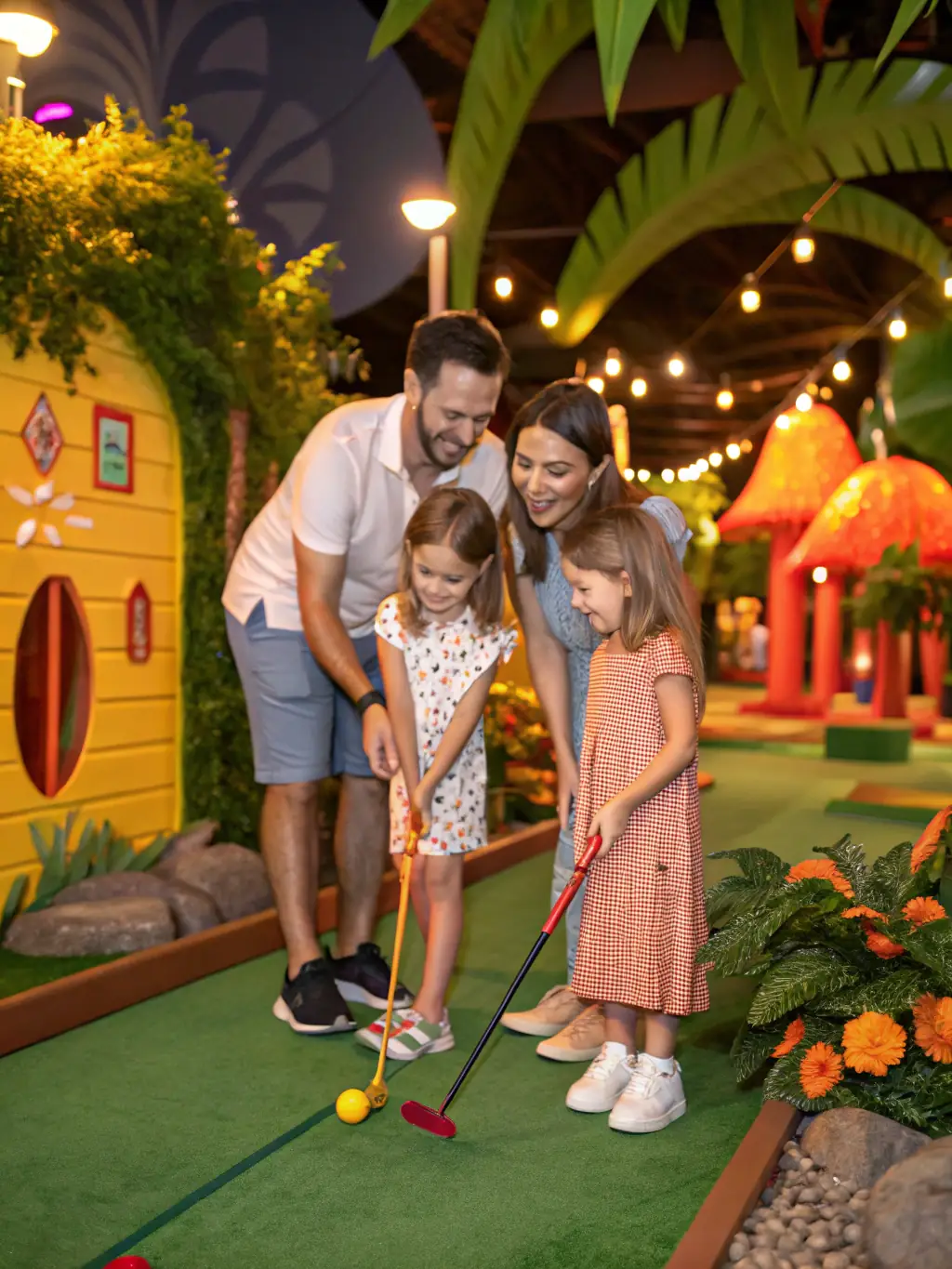 A family enjoying a weekend golf activity together, with parents and children smiling and playing on the course, highlighting inclusivity and togetherness.
